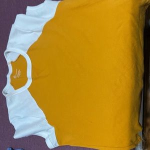 mustard yellow fitted crop top with short sleeves.